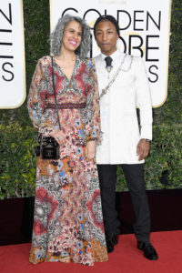 BEVERLY HILLS, CA - JANUARY 08: Musician Pharrell Williams (R) and Helen Lasichanh attend the 74th Annual Golden Globe Awards at The Beverly Hilton Hotel on January 8, 2017 in Beverly Hills, California. (Photo by Frazer Harrison/Getty Images)