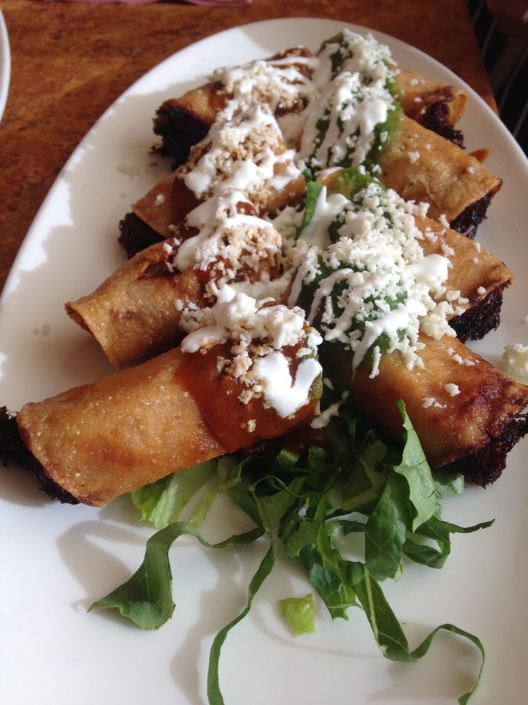 Flautas | Crispy corn tortilla, chicken tinga, salsa pasilla de Oaxaca, salsa verde, queso fresco, crema 