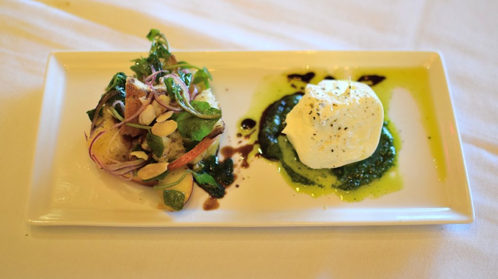 The best house-made burrata I've had all summer. Served with char-grilled Carolina peach panzanella, shaved red onions, basil pesto and Grand Marnier candied almonds